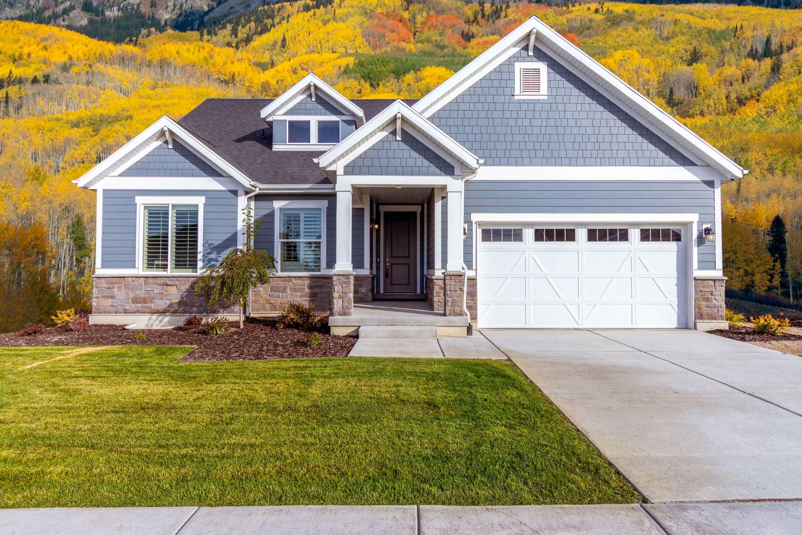Saskatoon home surrounded by autumn trees, ready for fall home maintenance before winter